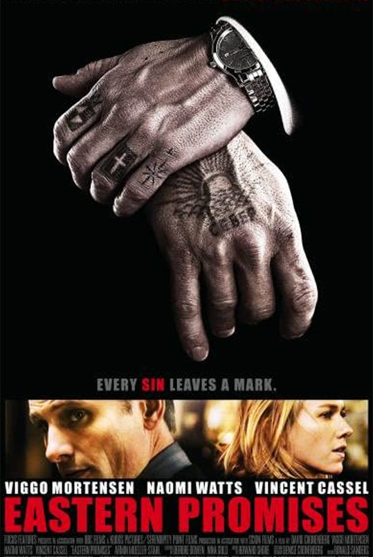 folded tattooed hands with pictures of Viggo Mortensen and Naomi watts and red "eastern promises" lettering