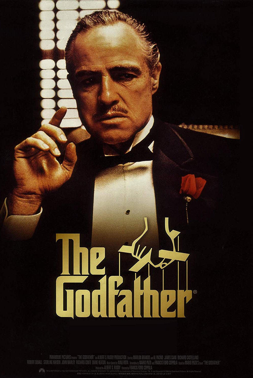 The Godfather Movie Poster with Marlon Brando as Vito Corleone in a tuxedo with a red rose in the chest pocket on the cover with golden letters