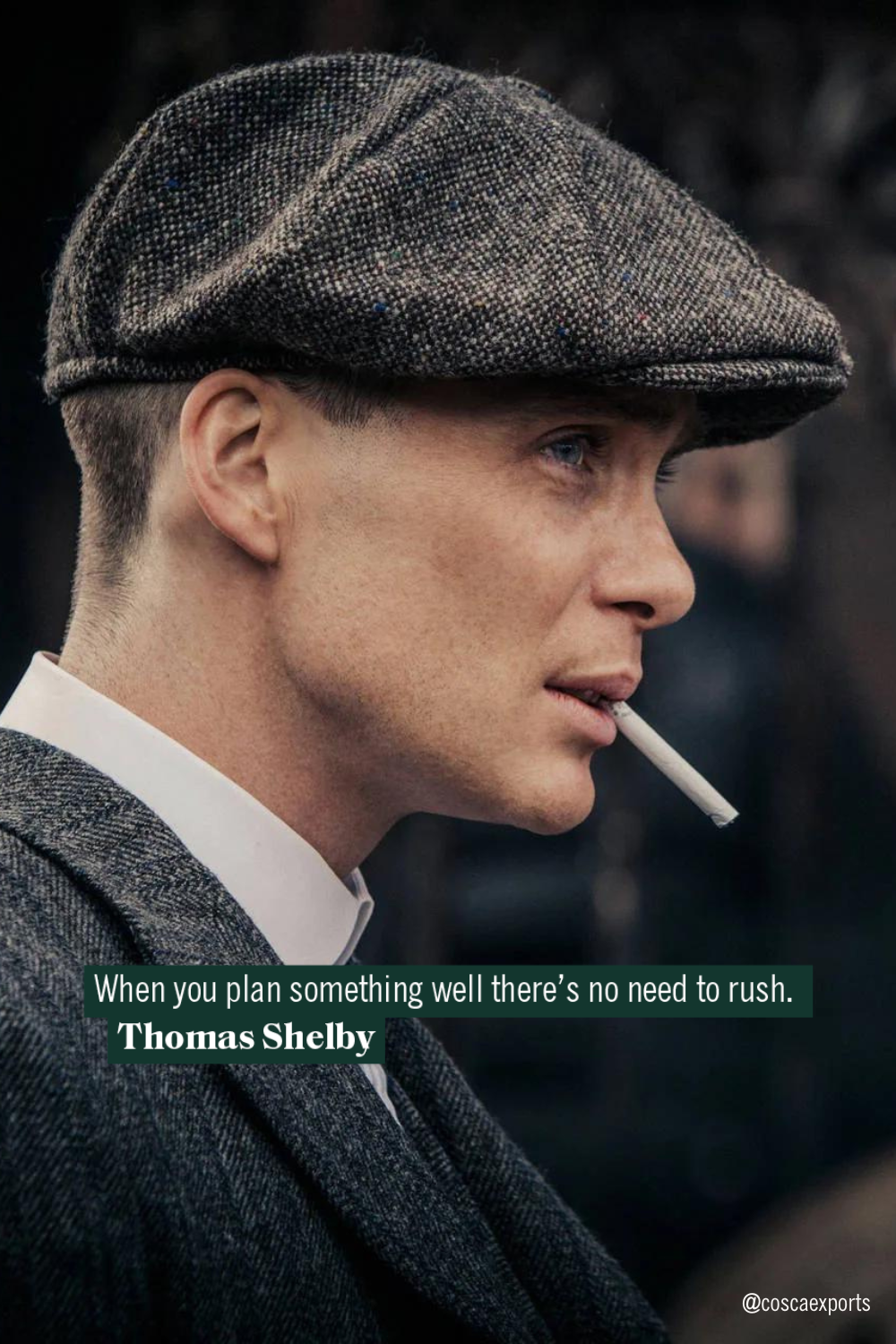 Cillian Murphy as Thomas Shelby in Peaky Blinders, wearing a flat cap and navy pinstripe suit before a train station. Quote: 'I’m not a traitor to my class... - Thomas Shelby.' Credit to @coscaexports.