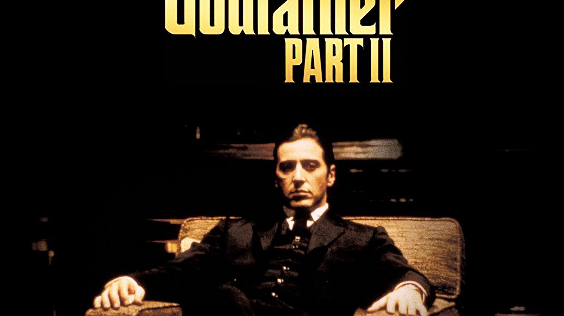 The Godfather Part II with Al Pacino as Michael Corleone sitting on a chair