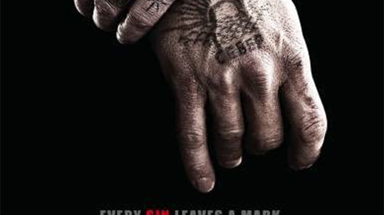 folded tattooed hands with pictures of Viggo Mortensen and Naomi watts and red "eastern promises" lettering 