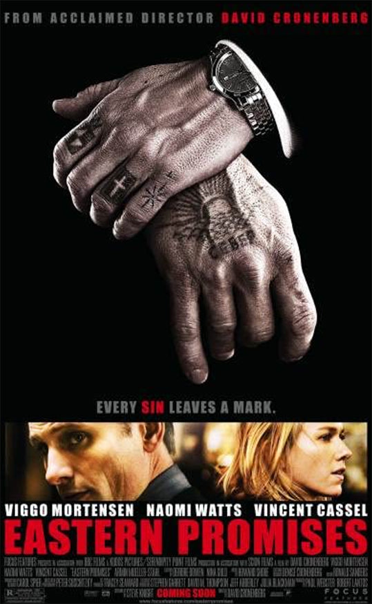 folded tattooed hands with pictures of Viggo Mortensen and Naomi watts and red "eastern promises" lettering 